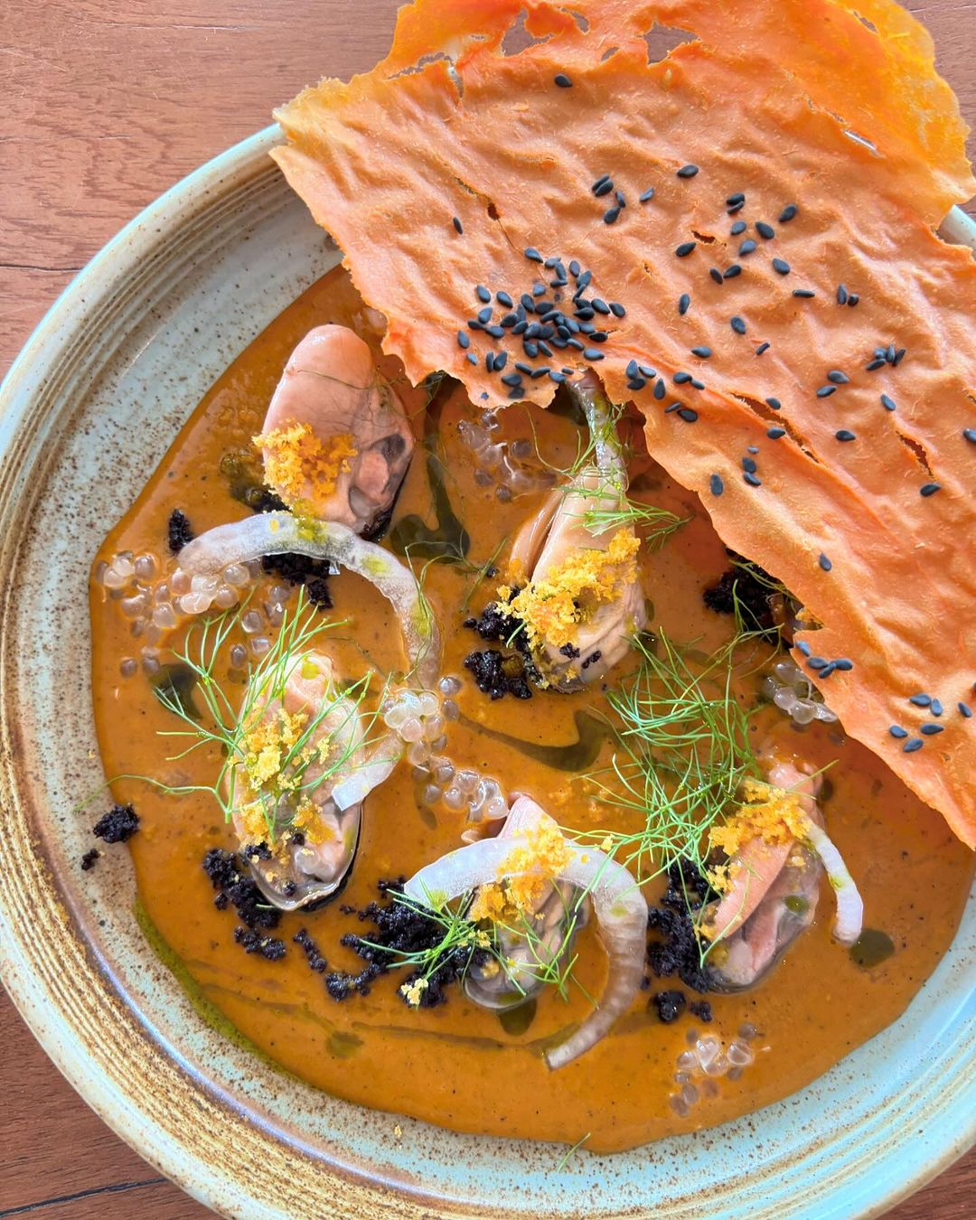 A colourful plated seafood dish with fresh garnishes by A Chef’s Pocket