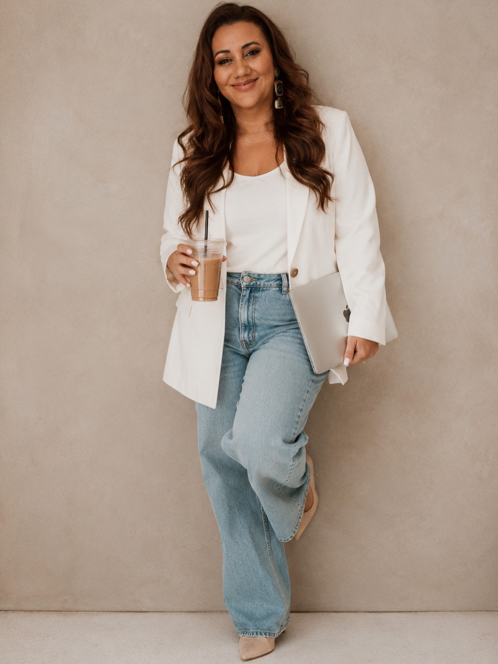 Ngaire Hogan standing in a white blazer and jeans against a neutral background.